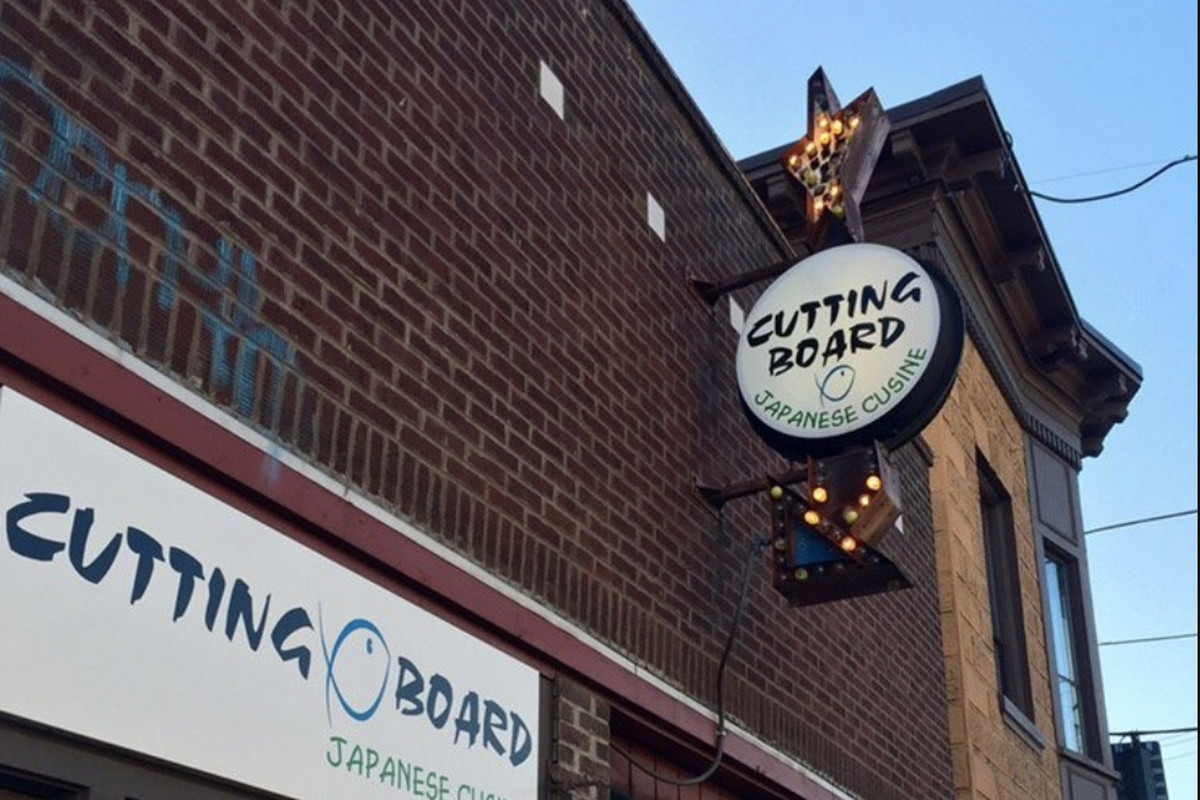 The brick exterior of Cutting Board in Georgetown, displaying the restaurant’s signage.
