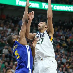 Utah Jazz center Rudy Gobert (27) shoots over Golden State Warriors forward Kevon Looney (5) during the game at Vivint Arena in Salt Lake City on Tuesday, April 10, 2018.