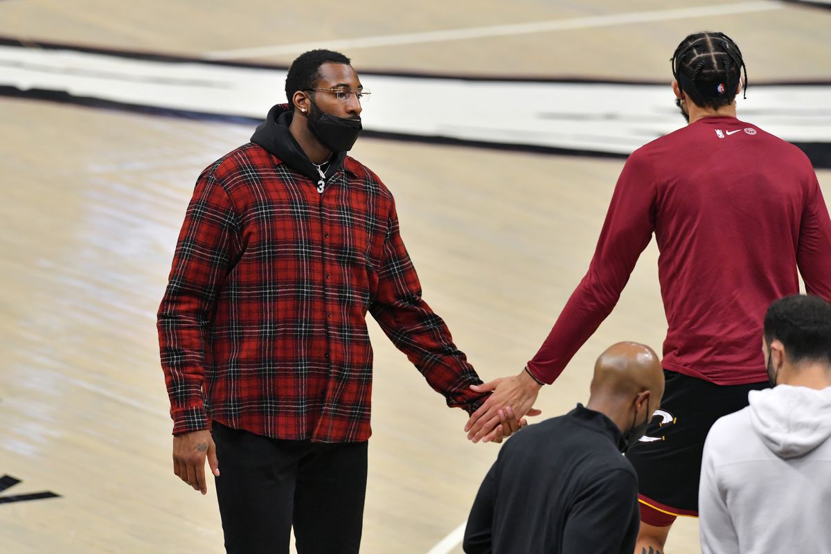 Andre Drummond celebrates with JaVale McGee of the Cleveland Cavaliers during a timeout during the second quarter against the Denver Nuggets at Rocket Mortgage Fieldhouse on February 19, 2021 in Cleveland, Ohio.
