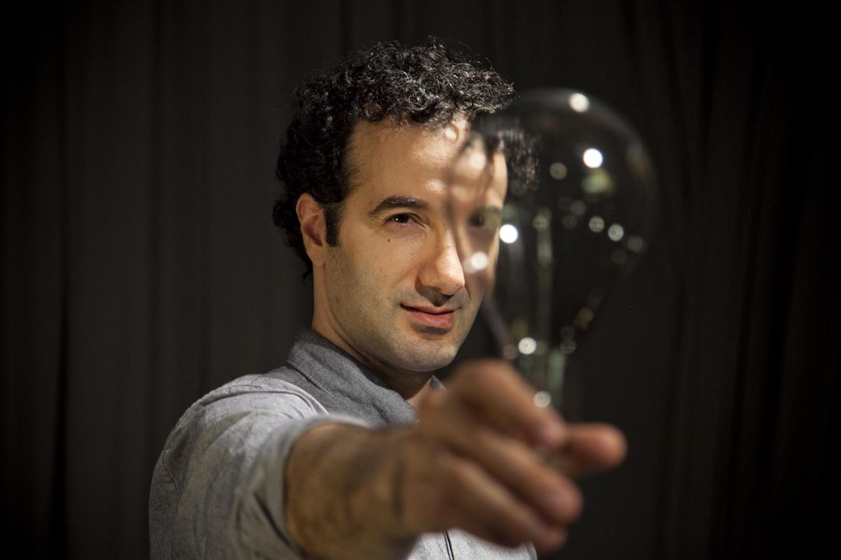 Jad Abumrad, creator of WNYC’s Radiolab and More Perfect, looks through a lightbulb