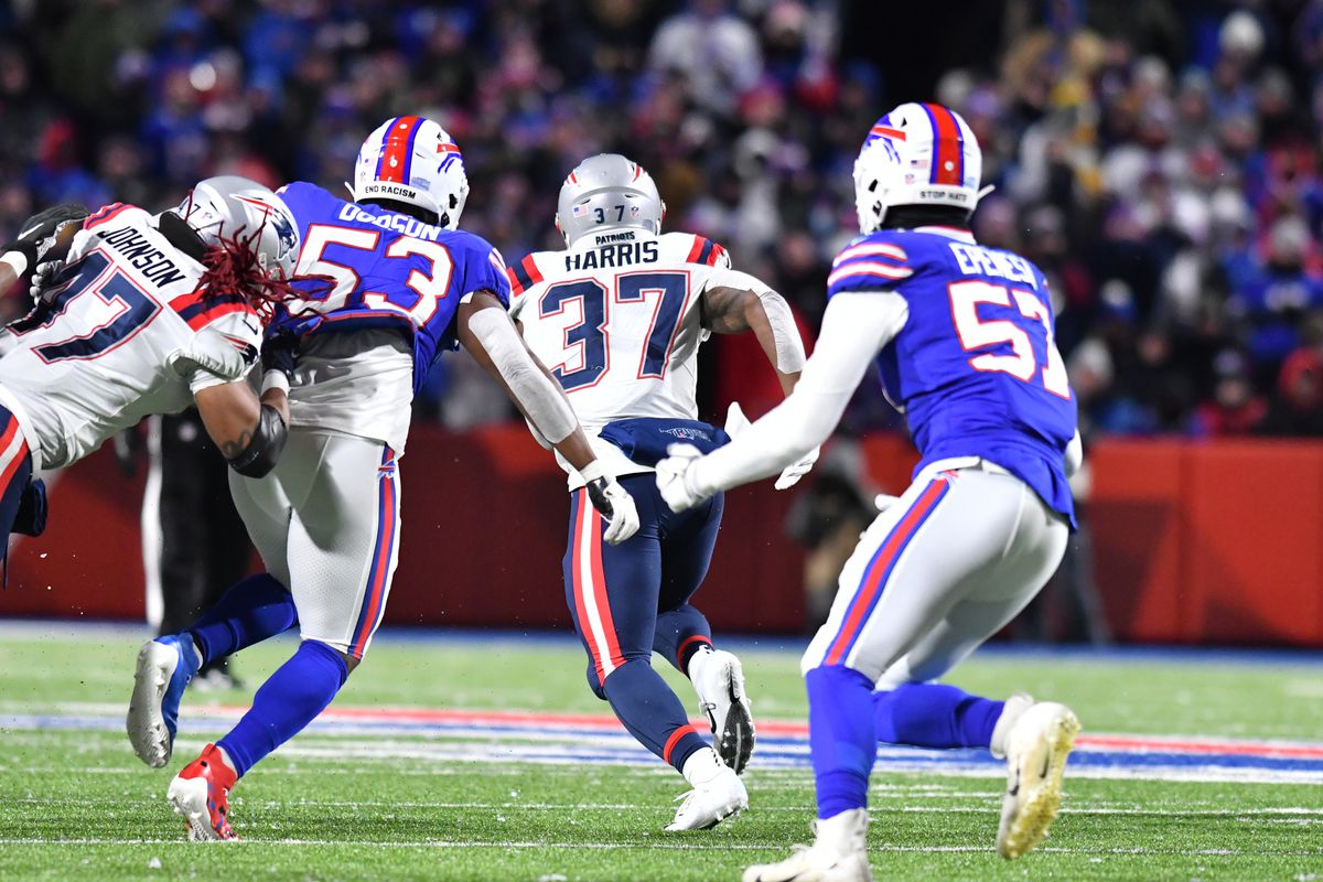 New England Patriots running back Damien Harris (37) breaks free past Buffalo Bills linebacker Tyrel Dodson (53) and defensive end A.J. Epenesa (57) to score a touchdown in the first quarter at Highmark Stadium.