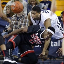 Elston Jones (50) of Utah State and Goodluck Okonoboh (11) of UNLV fight for the ball during NCAA basketball in Logan Tuesday, Feb. 24, 2015.

