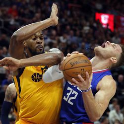 Utah Jazz forward Derrick Favors fouls LA Clippers forward Blake Griffin during NBA basketball in Salt Lake City on Saturday, Jan. 20, 2018.
