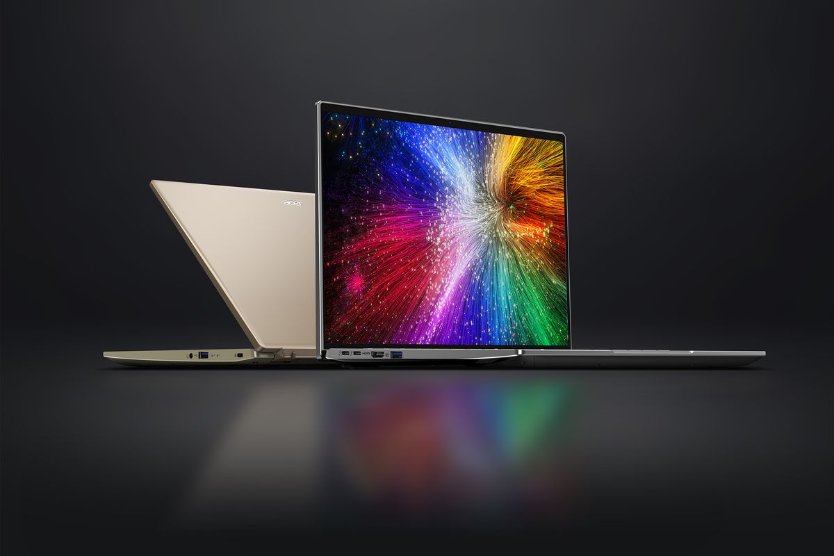 Two Acer Swift 3 models back to back on a black background. The visible screen displays a multicolor fireworks exhibition.