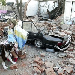 A woman sits in front a quake-damaged house in Talca, Chile, after a 8.8-magnitude earthquake struck the country early Feb. 27, 2010.