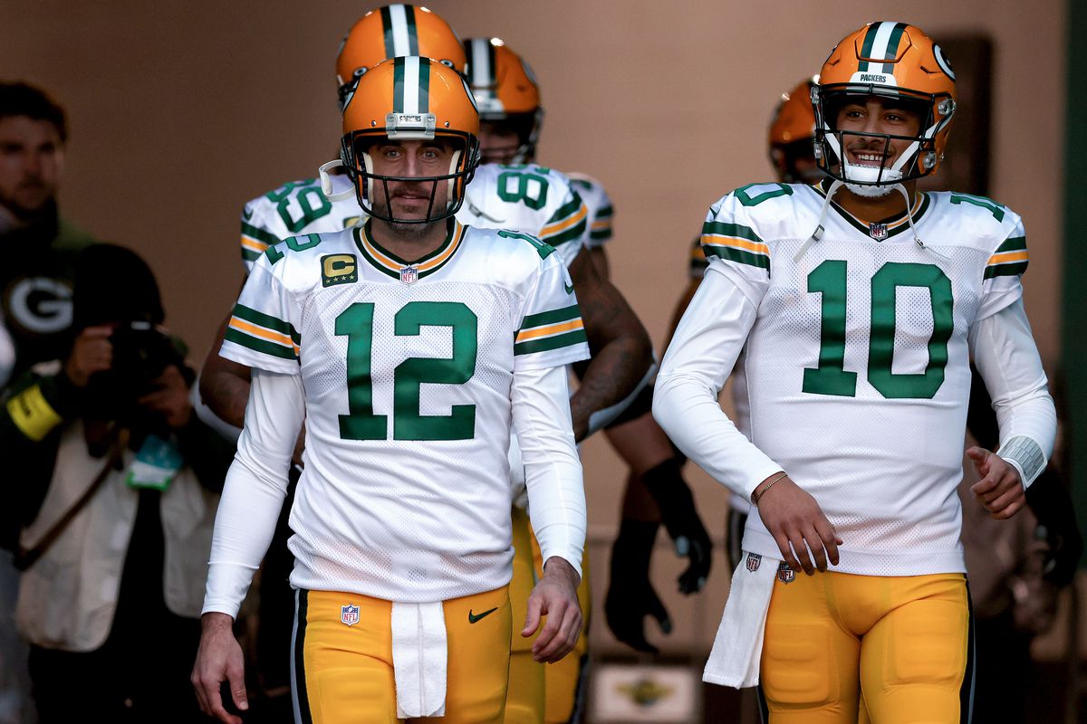 Aaron Rodgers #12 and Jordan Love #10 of the Green Bay Packers take the field prior to a game against the Miami Dolphins at Hard Rock Stadium on December 25, 2022 in Miami Gardens, Florida.