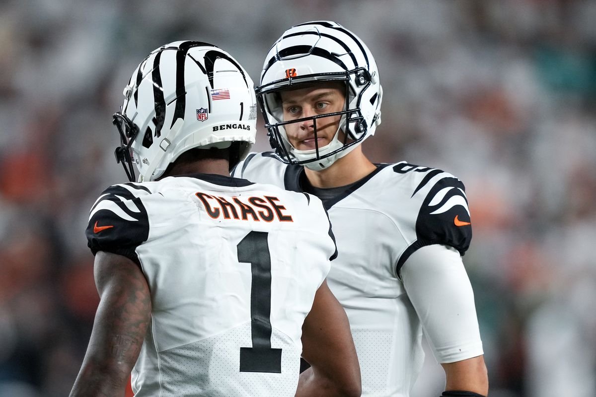 CINCINNATI, OHIO - SEPTEMBER 29: Ja’Marr Chase #1 and Joe Burrow #9 of the Cincinnati Bengals meet in the fourth quarter against the Miami Dolphins at Paycor Stadium on September 29, 2022 in Cincinnati, Ohio.