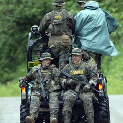 Law enforcement officers ride in an all-terrain vehicle as the search continues for two prison escapees from Clinton Correctional Facility in Dannemora, on Tuesday, June 23, 2015, in Malone, N.Y. Police began focusing intensely on an area 20 miles west of the prison that inmates David Sweat and Richard Matt escaped on June 6.  