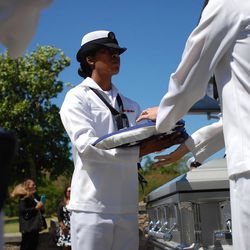 United States sailors remove the flag from the coffin carrying the remains of machinist’s mate Petty Officer 1st Class Vernon Luke of Green Bay, Wis., a sailor killed in the attack on Pearl Harbor, at his funeral service, Wednesday, March 9, 2016 in Honolulu. The 43-year-old was killed when Japanese planes bombed his battleship, the USS Oklahoma on Dec. 7, 1941. After World War II, he was buried as an “unknown” along with nearly 400 other unidentified sailors and Marines from the battleship. 