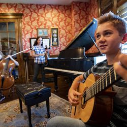 Matthew Baker plays his guitar and talks in -between songs as he joins with his mother Jenny Oaks Baker and sisters Laura, Hannah and Sarah as they rehearse at their North Salt Lake home on Monday, Aug. 19, 2019. They are preparing to perform for President Russell M. Nelson’s 95th birthday celebration.