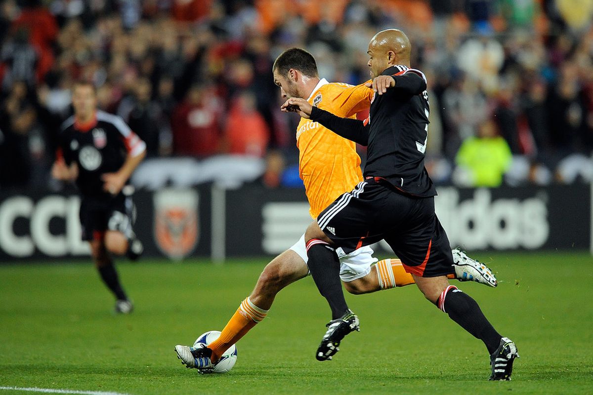 WASHINGTON, DC - APRIL 28:  Robbie Russell #3 of D.C. United battles with Will Bruin #12 of the Houston Dynamo at RFK Stadium on April 28, 2012 in Washington, DC.  (Photo by Patrick McDermott/Getty Images)