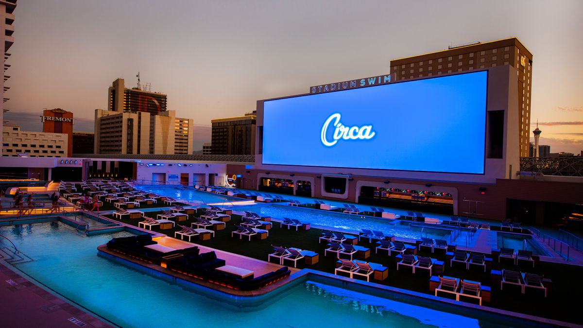 A pool with a view of a huge television screen