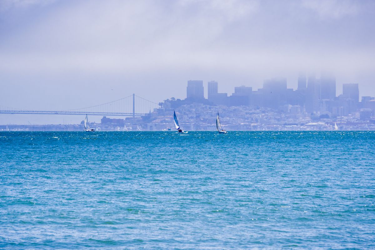A long shot of the San Francsco skyline from the water, almost completely obscured by fog.