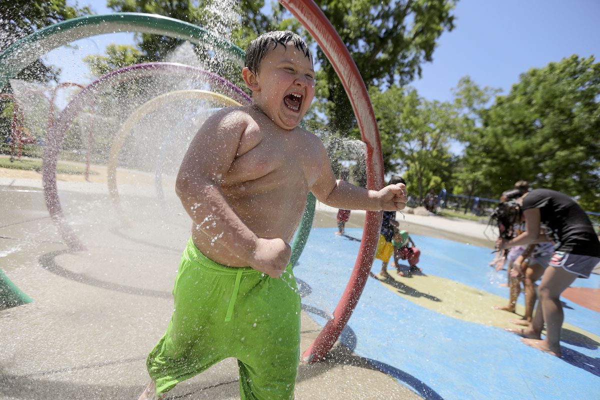 Jreydon Schreppel cools off in the splash pad at Liberty Park during a heat wave in Salt Lake City on Monday, June 14, 2021.