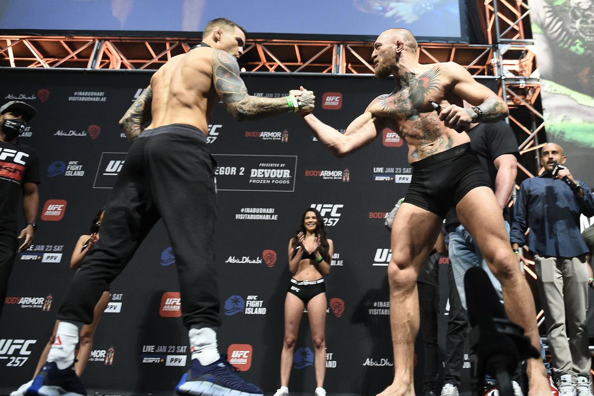 Opponents Dustin Poirier and Conor McGregor of Ireland face off during the UFC 257 weigh-in at Etihad Arena on UFC Fight Island on January 22, 2021 in Abu Dhabi, United Arab Emirates.