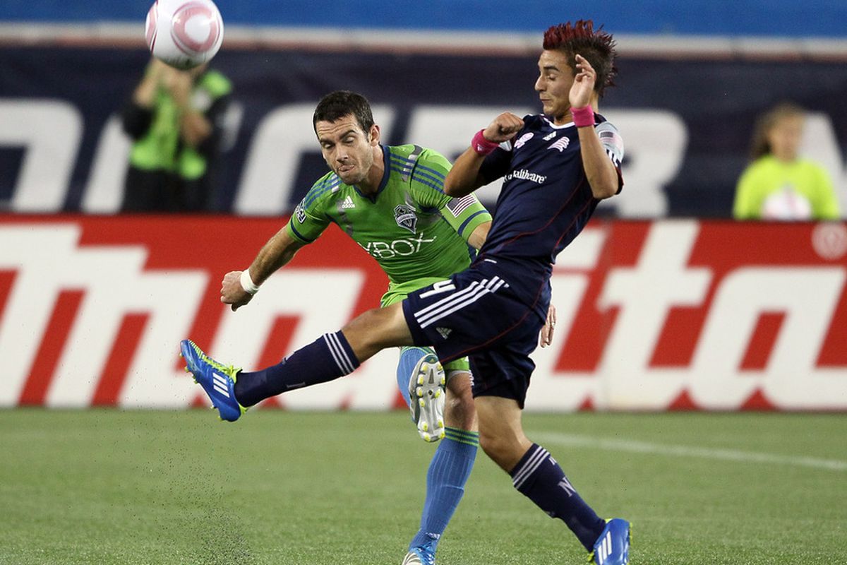 FOXBORO, MA - OCTOBER 01:  Zach Scott #20 of the Seattle Sounders FC and Diego Fagundez #14 of the New England Revolution battle for the ball on October 1, 2011 at Gillette Stadium in Foxboro, Massachusetts.  (Photo by Elsa/Getty Images)