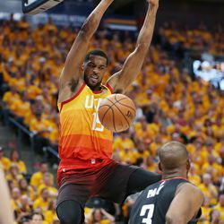 Utah Jazz forward Derrick Favors (15) dunks over Houston Rockets guard Chris Paul (3) during the NBA playoffs in Salt Lake City on Saturday, April 20, 2019.