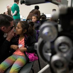 Dr. Jefferson Langford, left, gives Layla Lee, 5, an eye exam during SightFest at the Jordan School District Auxiliary Services building in West Jordan on Thursday, Dec. 8, 2016. SightFest is a partnership between Friends for Sight and the Utah Optometric Association that on Thursday provided free eye exams and glasses for 125 students from Title I schools in the Jordan School District.