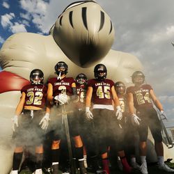 Lone Peak players wait to run onto the field as they and Herriman open the 2018-19 football season at Lone Peak on Friday, Aug. 17, 2018.