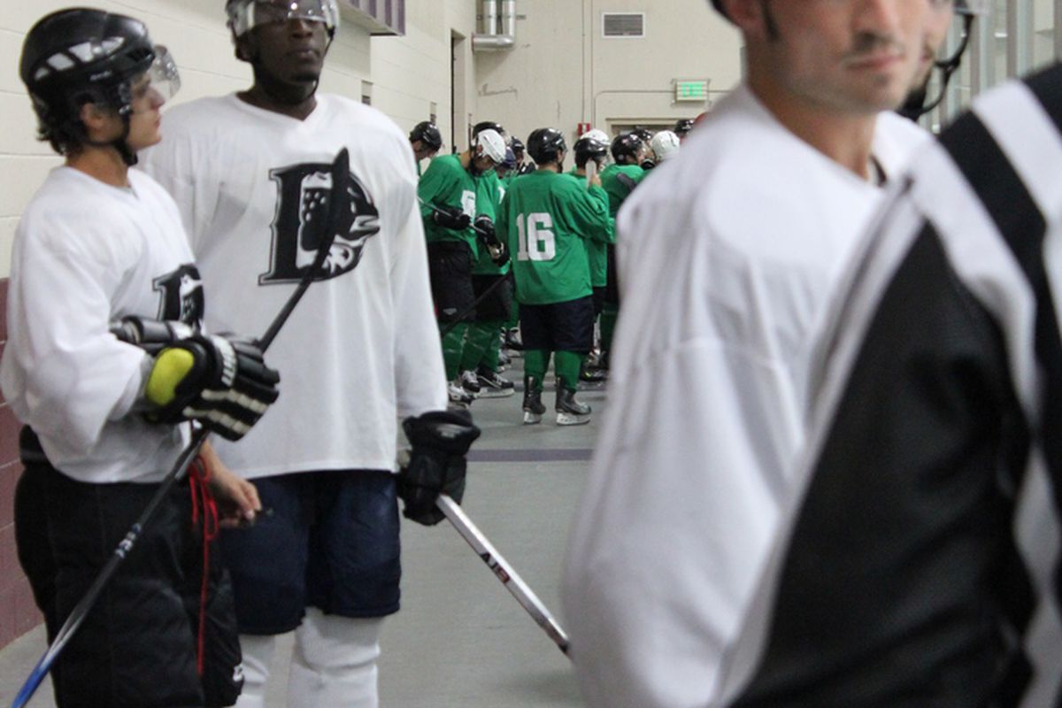August 11, 2012. Littleton, CO. Green and White teams wait for their final game of the day at the Denver Cutthroats open tryouts.