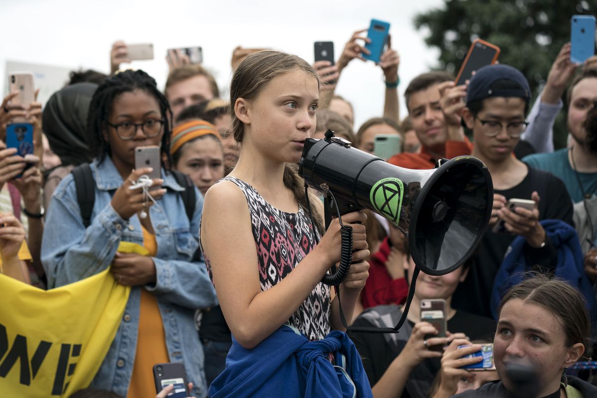 Swedish climate activist Greta Thunberg, 16, uses a bullhorn to speak to a crowd.
