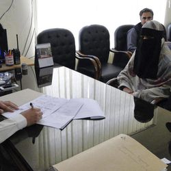 Badam Zari, right, gets her candidacy application for a parliamentary seat checked at the election office in Khar, capital of the  Pakistani tribal area of Bajur on Monday, April 1, 2013. A 40-year-old Pakistani housewife has made history by becoming the first woman to run for parliament from the country’s northwest tribal region, a highly conservative area that is a haven for Islamist militants. 