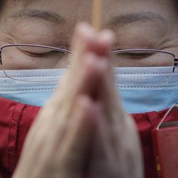 A Chinese woman prays on the first day of the Chinese Lunar New Year at Yonghegong Lama Temple in Beijing, China Thursday, Feb. 19, 2015. Chinese people are celebrating the Year of the Sheep on Thursday. 