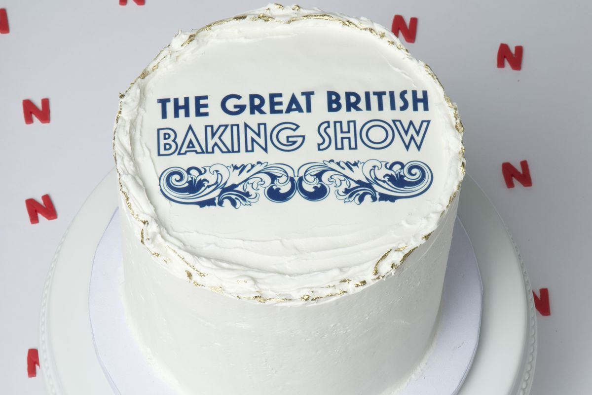 A cake decorated with the great british baking show logo