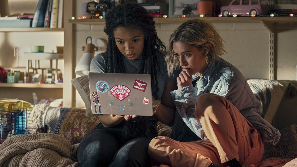 Marie (Jaz Sinclair) and Emma (Lizzie Broadway) look at something intently on the computer in Gen V