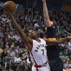 Toronto guard Kyle Lowry (7) attempts a layup past Utah forward Joe Ingles (2) during an NBA basketball game in Salt Lake City on Friday, Dec. 23, 2016. Toronto took down Utah with a final score of 104-98.