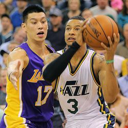 Utah Jazz guard Trey Burke (3) drives around Los Angeles Lakers guard Jeremy Lin (17) as the Jazz and the Lakers play Wednesday, Feb. 25, 2015, at EnergySolutions Arena in Salt Lake City.