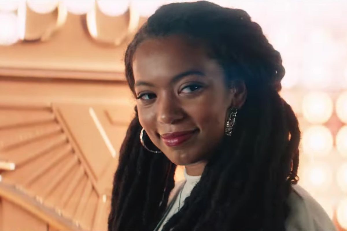 Jaz Sinclair smiles with blinding lights behind her in the Prime Video series Gen V