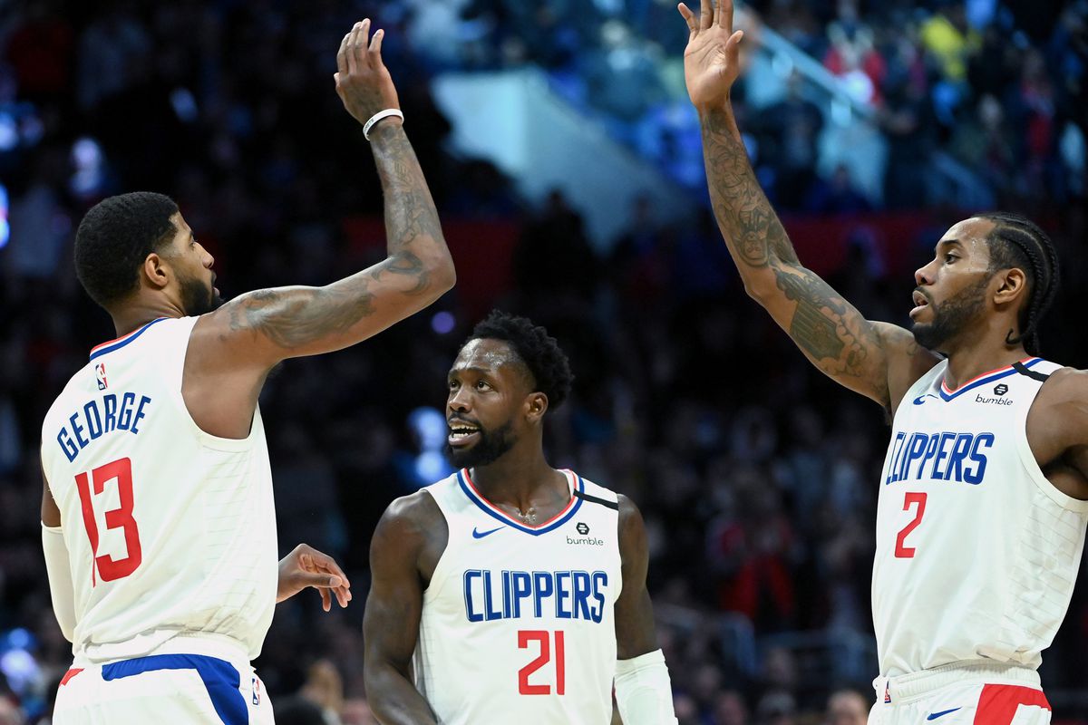 Los Angeles Clippers guard Paul George receives a high five from forward Kawhi Leonard after shooting the go ahead basket against the San Antonio Spurs as guard Patrick Beverley looks on in the second half at Staples Center.&nbsp;