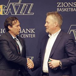 Quin Snyder, left, receives a hand shake from Utah Jazz CEO Greg Miller after being introduced as the new Utah Jazz head coach during a news conference Saturday, June 7, 2014, in Salt Lake City. The Utah Jazz announced Friday that they have hired Atlanta Hawks assistant coach Snyder to replace Tyrone Corbin, who was let go earlier this year after three-plus seasons in Salt Lake City. Snyder most recently completed his first season as an assistant with Atlanta. He has also been an assistant with the Los Angeles Lakers, the Philadelphia 76ers and the Los Angeles Clippers.  (AP Photo/Rick Bowmer)