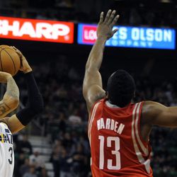 Utah Jazz point guard Trey Burke (3) shoots a pull-up jumper as Houston Rockets shooting guard James Harden (13) during a game at EnergySolutions Arena on Monday, Dec. 2, 2013.