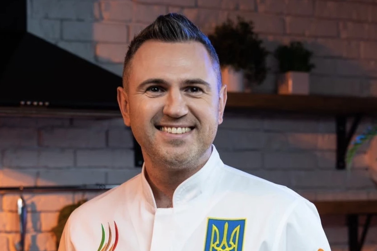 Chef Yurii&nbsp;Kovryzhenko, in a white jacket with the Ukrainian crest