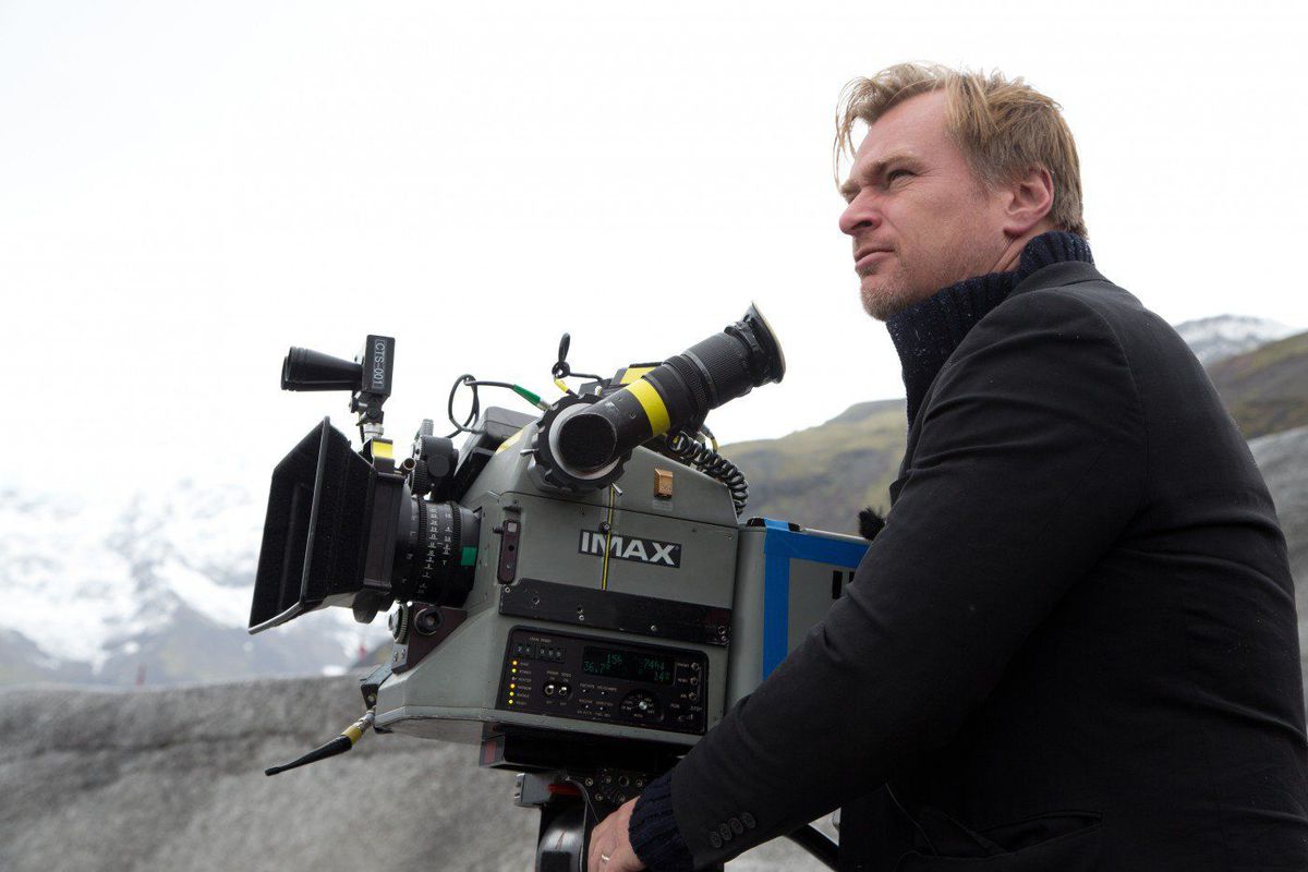 christopher nolan on the set of the dark knight rises, using an IMAX camera