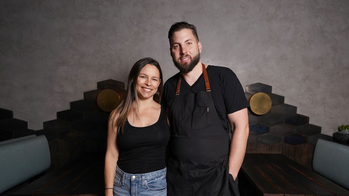 Caitlin and Daniel Cutler standing in the dining room of their LA restaurant Ronan.
