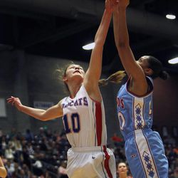 Panguitch's Darri Frandsen (10) reaches for a rebound against Piute's Asia Negron (40) as the Piute Thunderbirds play the Panguitch Bobcats in the girls 1A basketball championship at the Sevier Valley Center in Richfield Saturday, Feb. 21, 2015. The Bobcats beat the Thunderbirds, 58-28.