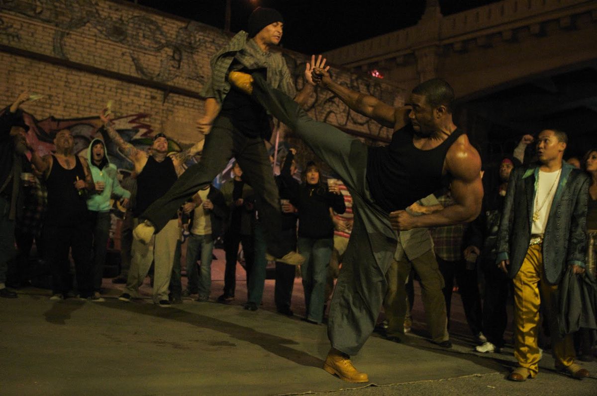 Michael Jai White kicks a man just so incredibly high in Blood and Bone, while Dante Basco looks on in awe.
