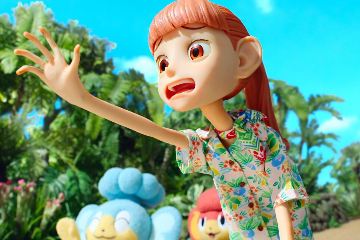 A still from the stop-animation show Pokemon Concierge. Haru reaches out with her hand beyond the camera and looks worried about something in the distance. She’s created with clay and her mouth is wide open in worry.