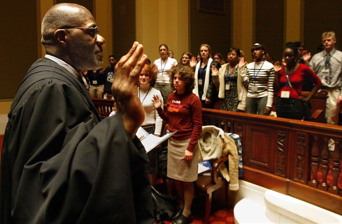 State Supreme Court justice Alan Page swears in highschool students who will be playing the role of supreme court justices during the Youth in Government activities at the Capitol. The ceremony took place in the chambers of the state supreme court at the