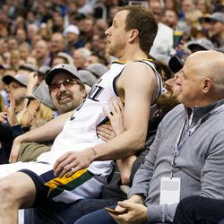 Utah forward Joe Ingles (2) ends up in the lap of a fan after saving the ball from out of bounds during the second half of an NBA basketball game against Golden State in Salt Lake City on Thursday, Dec. 8, 2016. Golden State defeated Utah with a final score of 106-99.