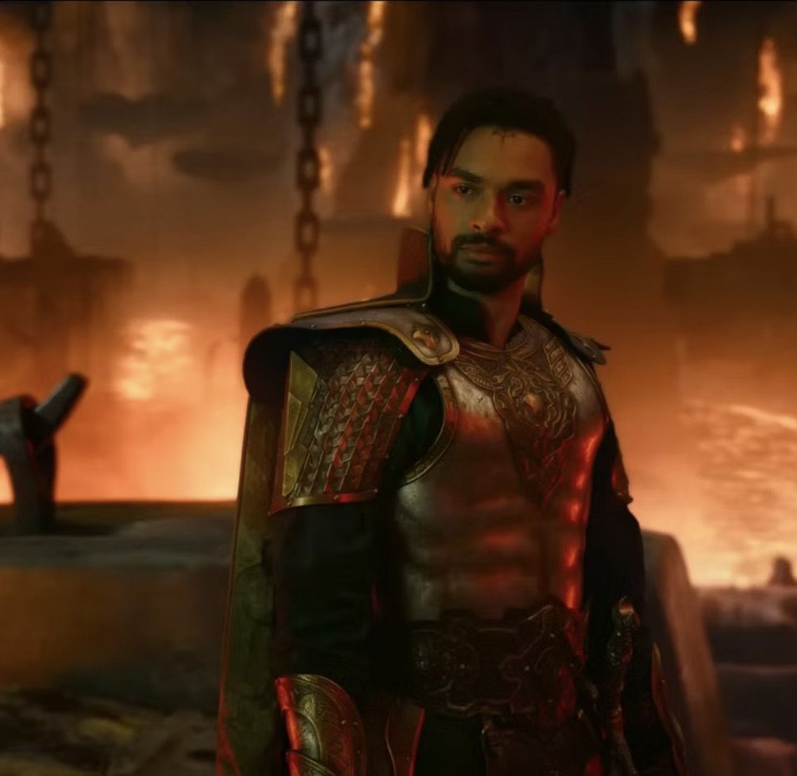 In a scene from the movie D&amp;D: Honor Among Thieves, Xenk (Rege-Jean Page), a paladin wearing ornate metal armor, looks disapproving, with a ruined bridge behind him.