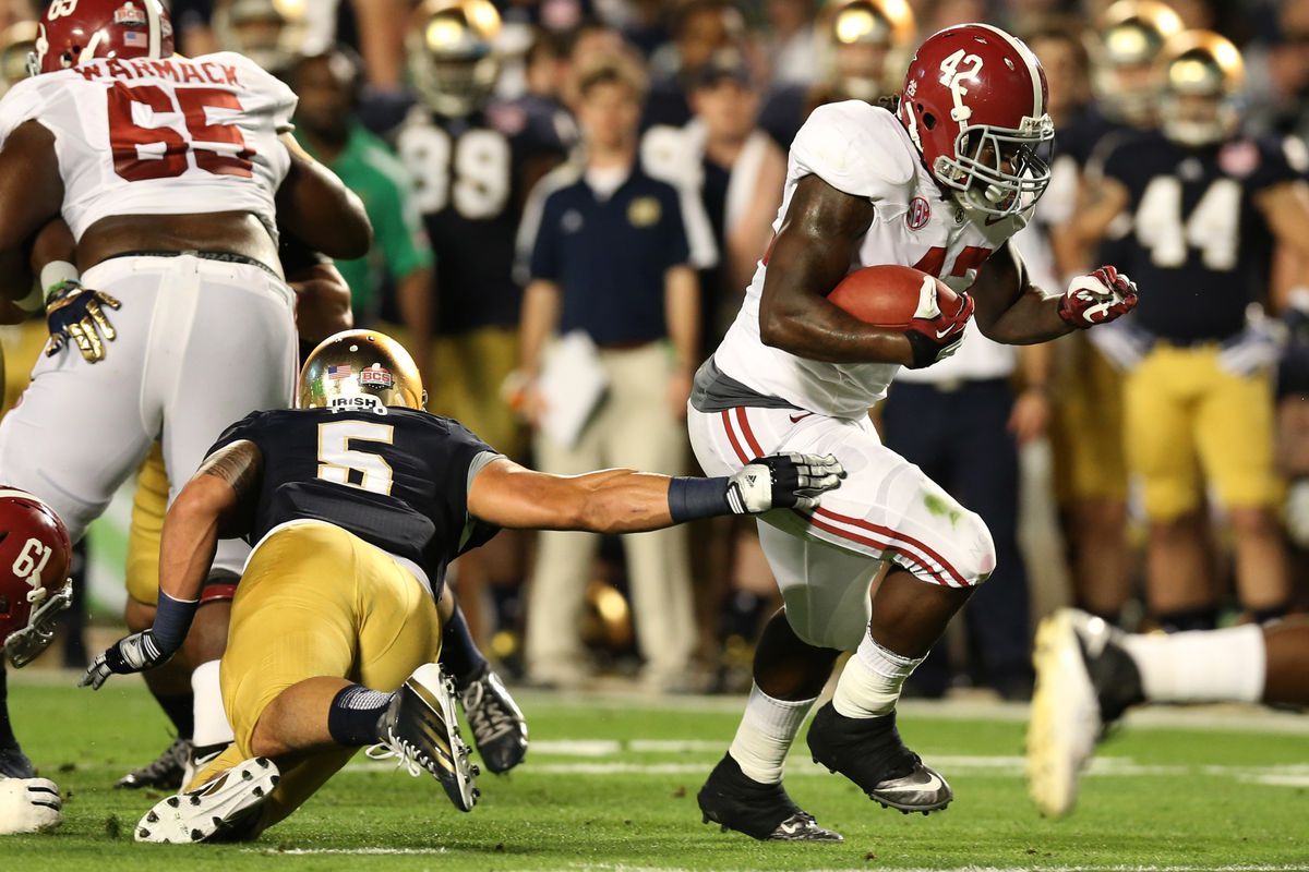 Lacy breaks a would-be Manti Te'o tackle in the BCS National Championship game.