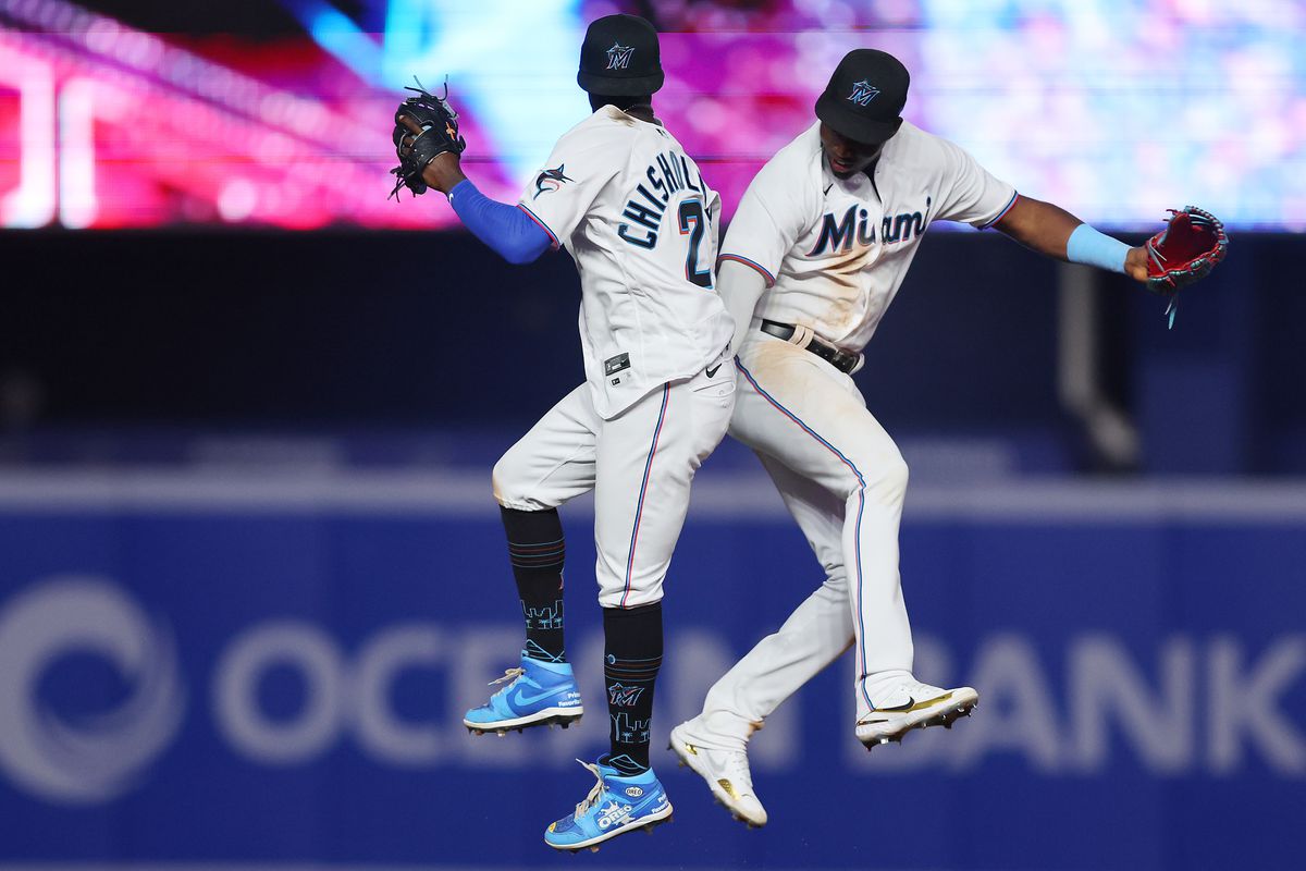 Jazz Chisholm Jr. #2 and Jesus Sanchez #7 of the Miami Marlins celebrate after defeating the Seattle Mariners 8-6 at loanDepot park