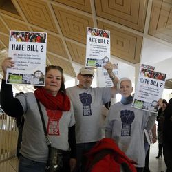 Opponents of House Bill 2 hold signs outside the  House chambers gallery as the North Carolina General Assembly convenes for a special session at the Legislative Building in Raleigh, N.C., Wednesday, Dec. 21, 2016. North Carolina's Republican legislature is reconvening to see if enough lawmakers are now willing to repeal a 9-month-old law that limited LGBT rights, including where transgender people can use bathrooms in schools and government buildings. 