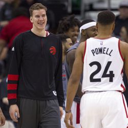 Toronto center Jakob Poeltl (42) smiles at guard Norman Powell (24) during the final seconds of an NBA basketball game against Utah in Salt Lake City on Friday, Dec. 23, 2016. Toronto took down Utah with a final score of 104-98.