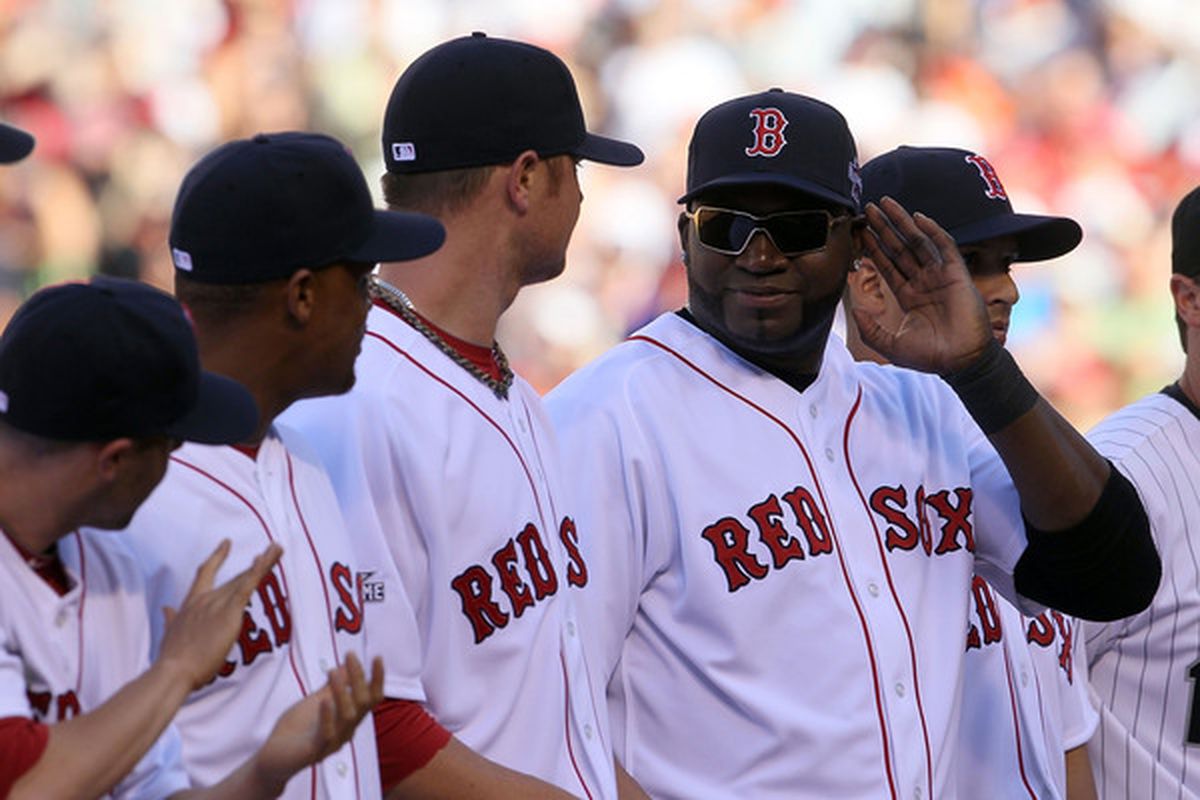 Vampire David Ortiz desperately attempts to hide his face from the harsh, burning glow of the afternoon sun.   (Photo by Jeff Gross/Getty Images)