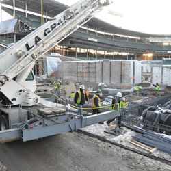 The crane being used to hoist the bucket of concrete to the right field stands along Sheffield